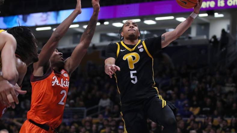 Pittsburgh Panthers Ishmael Leggett (5) goes for a layup after getting around Virginia Tech Hokies MJ Collins (2) during the first half on February 24, 2024 at the Petersen Events Center in Pittsburgh, PA.