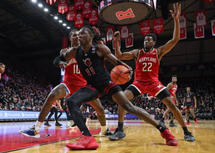 Feb 25, 2024; Piscataway, New Jersey, USA; Rutgers Scarlet Knights center Clifford Omoruyi (11) dribbles in front of Maryland Terrapins forward Julian Reese (10) and forward Jordan Geronimo (22) during the second half at Jersey Mike's Arena. Mandatory Credit: Vincent Carchietta-USA TODAY Sports