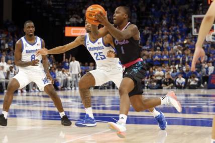 Feb 25, 2024; Memphis, Tennessee, USA; Florida Atlantic Owls guard Johnell Davis (1) drives to the basket as Memphis Tigers guard Jayden Hardaway (25) defends during the second half at FedExForum. Mandatory Credit: Petre Thomas-USA TODAY Sports