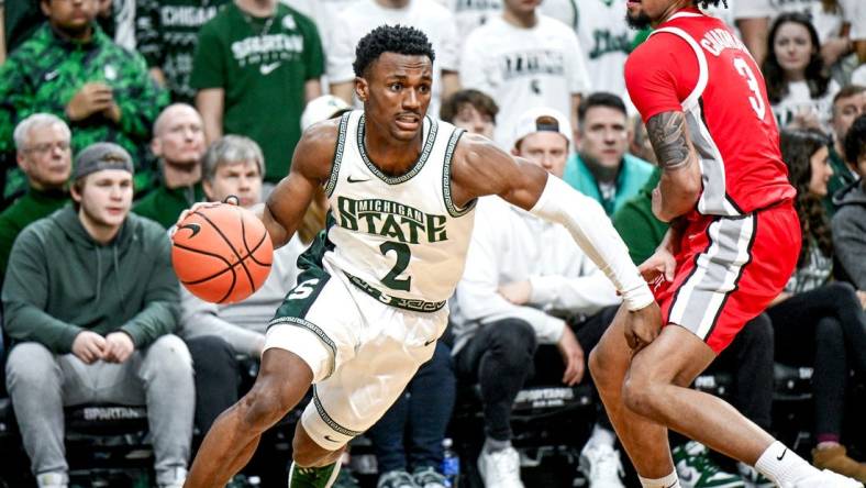 Michigan State's Tyson Walker, left, moves past Ohio State's Taison Chatman during the first half on Sunday, Feb. 25, 2024, at the Breslin Center in East Lansing.