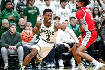 Michigan State's Tyson Walker, left, moves past Ohio State's Taison Chatman during the first half on Sunday, Feb. 25, 2024, at the Breslin Center in East Lansing.