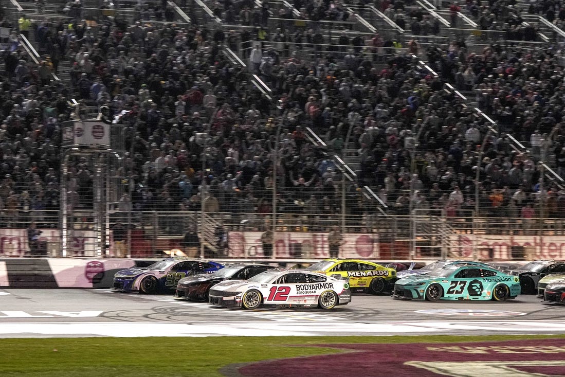 Feb 25, 2024; Hampton, Georgia, USA; NASCAR Cup Series driver Daniel Suarez (99) (near wall) beats NASCAR Cup Series driver Ryan Blaney (12) to the line to win the Ambetter Health 400 at Atlanta Motor Speedway. Mandatory Credit: David Yeazell-USA TODAY Sports