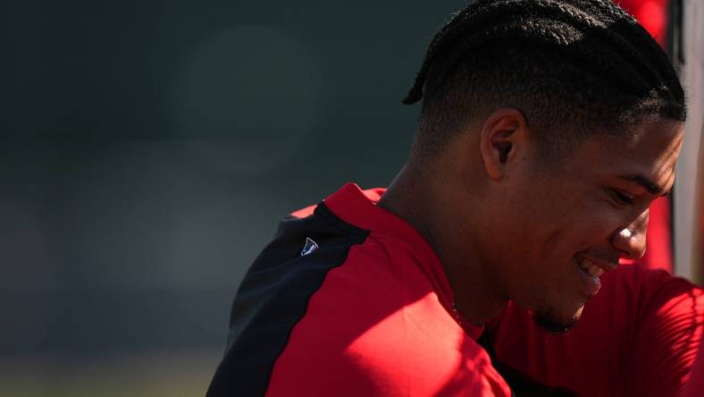 Cincinnati Reds shortstop Noelvi Marte (16) smiles while waiting for his turn to take batting practice during spring training workouts, Thursday, Feb. 15, 2024, at the team   s spring training facility in Goodyear, Ariz.