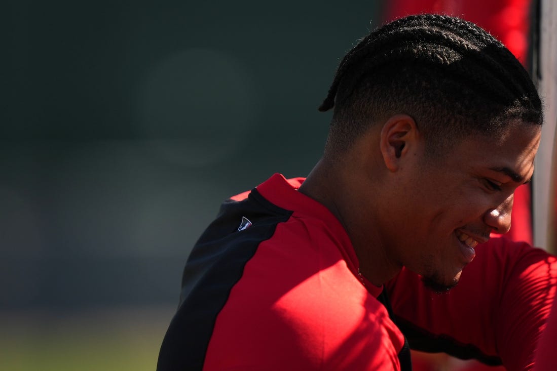 Cincinnati Reds shortstop Noelvi Marte (16) smiles while waiting for his turn to take batting practice during spring training workouts, Thursday, Feb. 15, 2024, at the team   s spring training facility in Goodyear, Ariz.