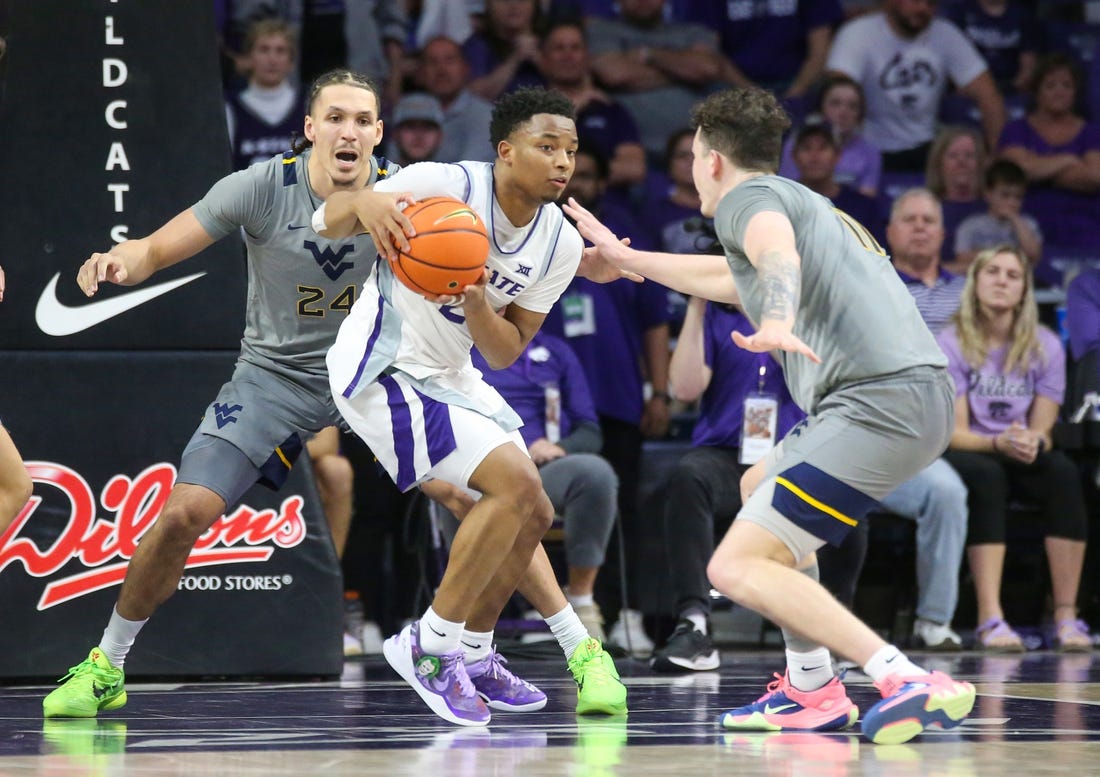 Feb 26, 2024; Manhattan, Kansas, USA; Kansas State Wildcats guard Tylor Perry (2) is dribbles as West Virginia Mountaineers forwards Patrick Suemnick (24) and Quinn Slazinski (11) defend during overtime at Bramlage Coliseum. Mandatory Credit: Scott Sewell-USA TODAY Sports