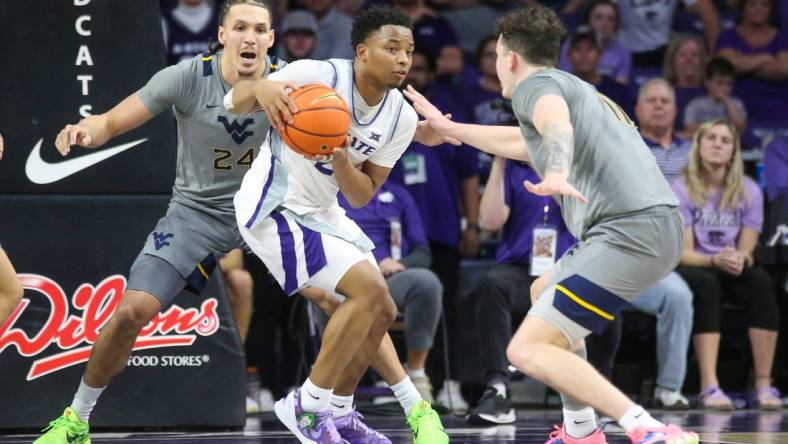 Feb 26, 2024; Manhattan, Kansas, USA; Kansas State Wildcats guard Tylor Perry (2) is dribbles as West Virginia Mountaineers forwards Patrick Suemnick (24) and Quinn Slazinski (11) defend during overtime at Bramlage Coliseum. Mandatory Credit: Scott Sewell-USA TODAY Sports