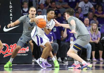 Feb 26, 2024; Manhattan, Kansas, USA; Kansas State Wildcats guard Tylor Perry (2) is dribbles as West Virginia Mountaineers forwards Patrick Suemnick (24) and Quinn Slazinski (11) defend during overtime at Bramlage Coliseum. Mandatory Credit: Scott Sewell-USA TODAY Sports