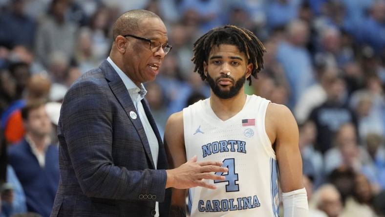 Feb 26, 2024; Chapel Hill, North Carolina, USA; North Carolina Tar Heels coach Hubert Davis with guard RJ Davis (4) in the second half at Dean E. Smith Center. Mandatory Credit: Bob Donnan-USA TODAY Sports