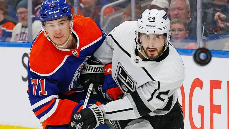 Feb 26, 2024; Edmonton, Alberta, CAN; Edmonton Oilers forward Ryan McLeod (71) and Los Angeles Kings forward Phillip Danault (24) follow a loose puck during the second period at Rogers Place. Mandatory Credit: Perry Nelson-USA TODAY Sports