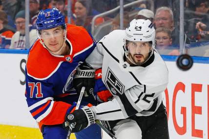 Feb 26, 2024; Edmonton, Alberta, CAN; Edmonton Oilers forward Ryan McLeod (71) and Los Angeles Kings forward Phillip Danault (24) follow a loose puck during the second period at Rogers Place. Mandatory Credit: Perry Nelson-USA TODAY Sports