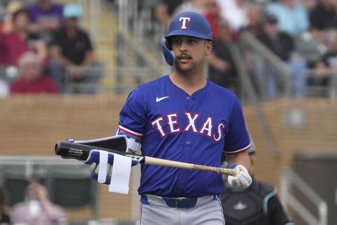 Feb 27, 2024; Salt River Pima-Maricopa, Arizona, USA; Texas Rangers first baseman Nathaniel Lowe (30) reacts after walking against the Arizona Diamondbacks during the first inning at Salt River Fields at Talking Stick. Mandatory Credit: Rick Scuteri-USA TODAY Sports