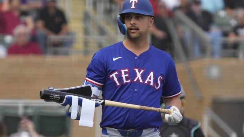 Feb 27, 2024; Salt River Pima-Maricopa, Arizona, USA; Texas Rangers first baseman Nathaniel Lowe (30) reacts after walking against the Arizona Diamondbacks during the first inning at Salt River Fields at Talking Stick. Mandatory Credit: Rick Scuteri-USA TODAY Sports