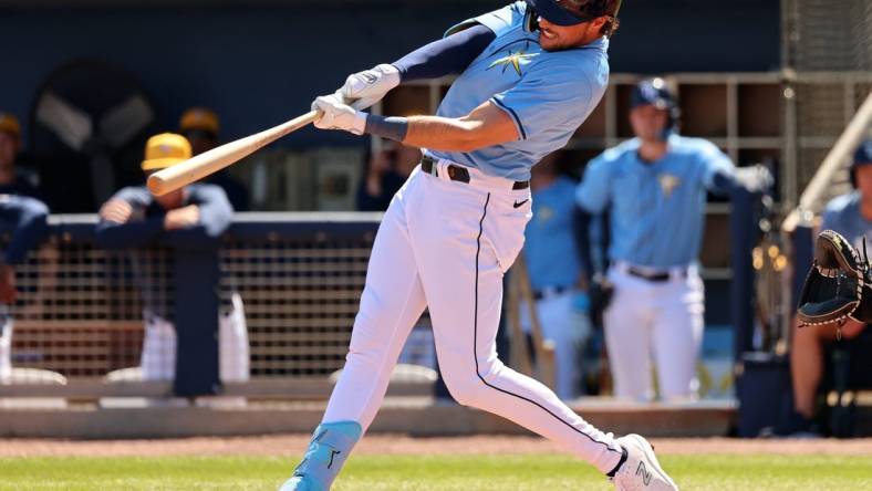 Feb 27, 2024; Port Charlotte, Florida, USA;  Tampa Bay Rays right fielder Josh Lowe (15) doubles during the second inning against the New York Yankees at Charlotte Sports Park. Mandatory Credit: Kim Klement Neitzel-USA TODAY Sports