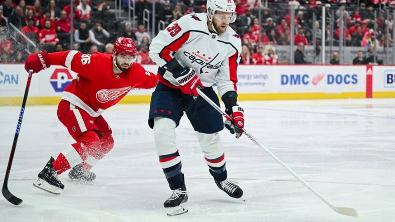 Feb 27, 2024; Detroit, Michigan, USA; Washington Capitals right wing Anthony Mantha (39) brings the puck up ice against Detroit Red Wings defenseman Jake Walman (96) during the first period at Little Caesars Arena. Mandatory Credit: Tim Fuller-USA TODAY Sports