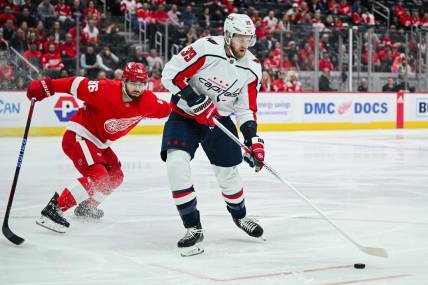 Feb 27, 2024; Detroit, Michigan, USA; Washington Capitals right wing Anthony Mantha (39) brings the puck up ice against Detroit Red Wings defenseman Jake Walman (96) during the first period at Little Caesars Arena. Mandatory Credit: Tim Fuller-USA TODAY Sports