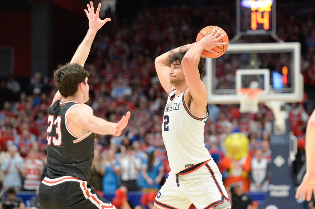 Feb 27, 2024; Dayton, Ohio, USA;  Dayton Flyers forward Nate Santos (2) passes the ball against Davidson Wildcats guard Connor Kochera (23) during the second half of the game at University of Dayton Arena. Mandatory Credit: Matt Lunsford-USA TODAY Sports