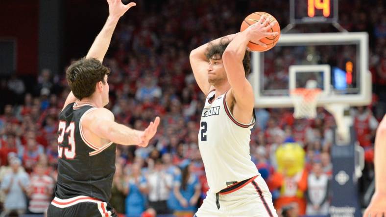 Feb 27, 2024; Dayton, Ohio, USA;  Dayton Flyers forward Nate Santos (2) passes the ball against Davidson Wildcats guard Connor Kochera (23) during the second half of the game at University of Dayton Arena. Mandatory Credit: Matt Lunsford-USA TODAY Sports