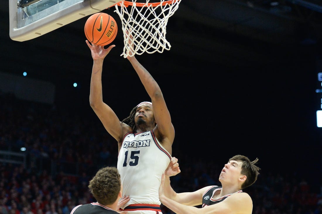 Feb 27, 2024; Dayton, Ohio, USA;  Dayton Flyers forward DaRon Holmes II (15) shoots the ball against Davidson Wildcats  guard Achile Spadone (3) and forward Sean Logan (15) during the second half of the game at University of Dayton Arena. Mandatory Credit: Matt Lunsford-USA TODAY Sports