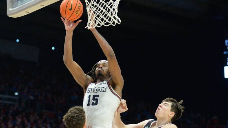 Feb 27, 2024; Dayton, Ohio, USA;  Dayton Flyers forward DaRon Holmes II (15) shoots the ball against Davidson Wildcats  guard Achile Spadone (3) and forward Sean Logan (15) during the second half of the game at University of Dayton Arena. Mandatory Credit: Matt Lunsford-USA TODAY Sports