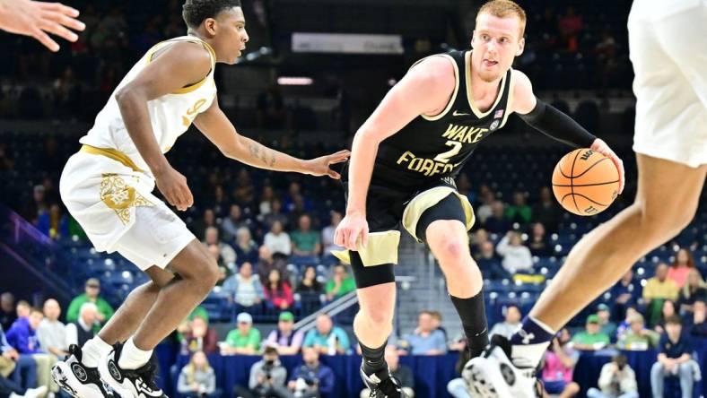 Feb 27, 2024; South Bend, Indiana, USA; Wake Forest Demon Deacons guard Cameron Hildreth (2) dribbles as Notre Dame Fighting Irish guard Markus Burton (3) defends in the second half at the Purcell Pavilion. Mandatory Credit: Matt Cashore-USA TODAY Sports