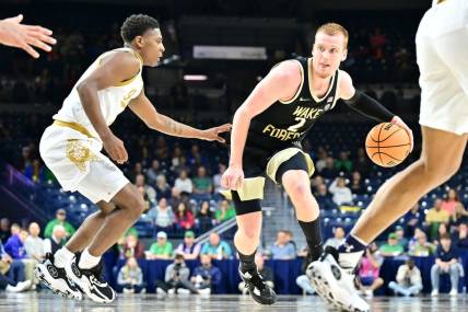 Feb 27, 2024; South Bend, Indiana, USA; Wake Forest Demon Deacons guard Cameron Hildreth (2) dribbles as Notre Dame Fighting Irish guard Markus Burton (3) defends in the second half at the Purcell Pavilion. Mandatory Credit: Matt Cashore-USA TODAY Sports