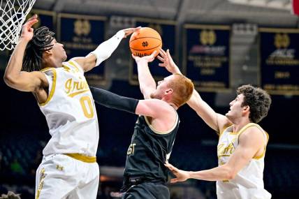 Feb 27, 2024; South Bend, Indiana, USA; Wake Forest Demon Deacons guard Cameron Hildreth (2) goes up for a shot as Notre Dame Fighting Irish forward Carey Booth (0) and guard Logan Imes (2) defend in the second half at the Purcell Pavilion. Mandatory Credit: Matt Cashore-USA TODAY Sports