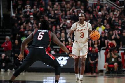 Feb 27, 2024; Lubbock, Texas, USA;  UT Longhorns guard Max Abmas (3) dribbles the ball against Texas Tech Red Raiders guard Joe Toussaint (6) in the first half at United Supermarkets Arena. Mandatory Credit: Michael C. Johnson-USA TODAY Sports