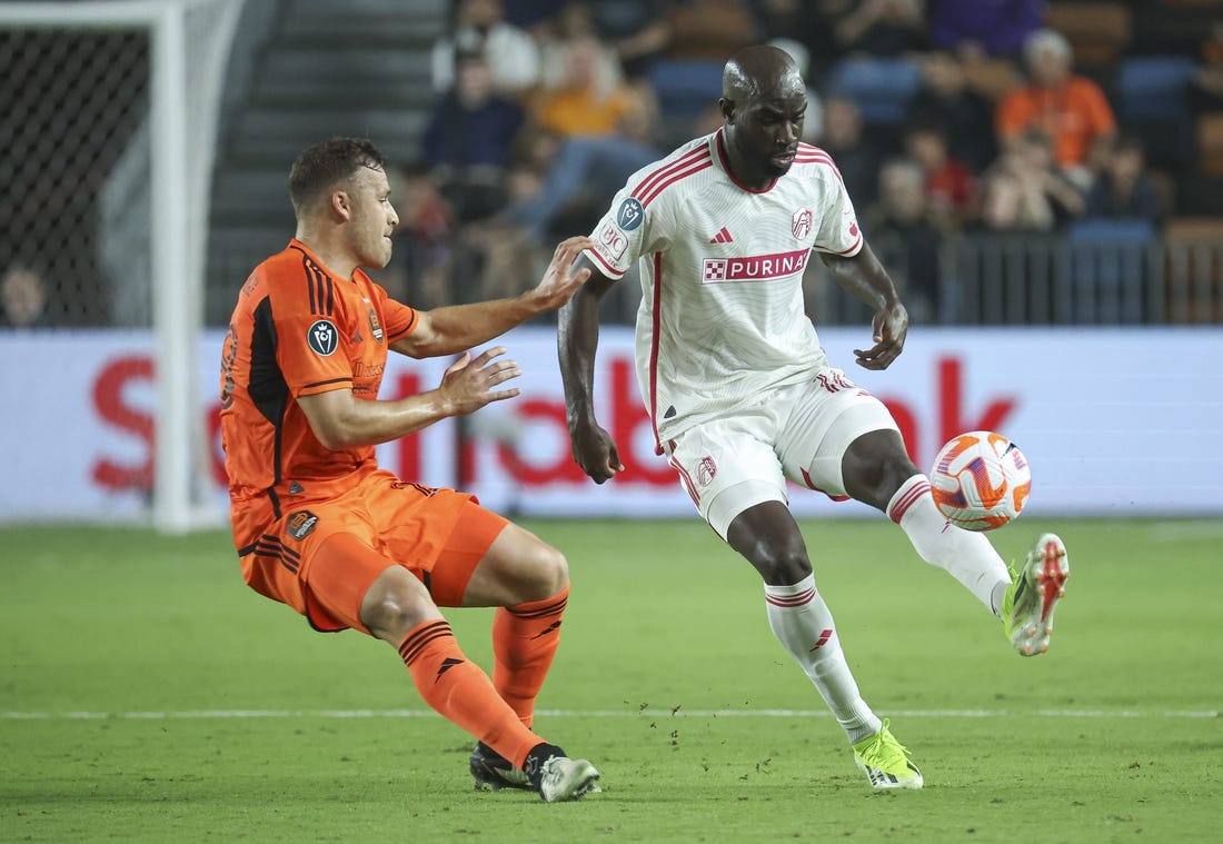 Feb 27, 2024; Houston, TX, USA; St. Louis CITY SC forward Samuel Adeniran (16) attempts to control the ball as Houston Dynamo FC defender Erik Sviatchenko (28) defends during the second half at Shell Energy Stadium. Mandatory Credit: Troy Taormina-USA TODAY Sports