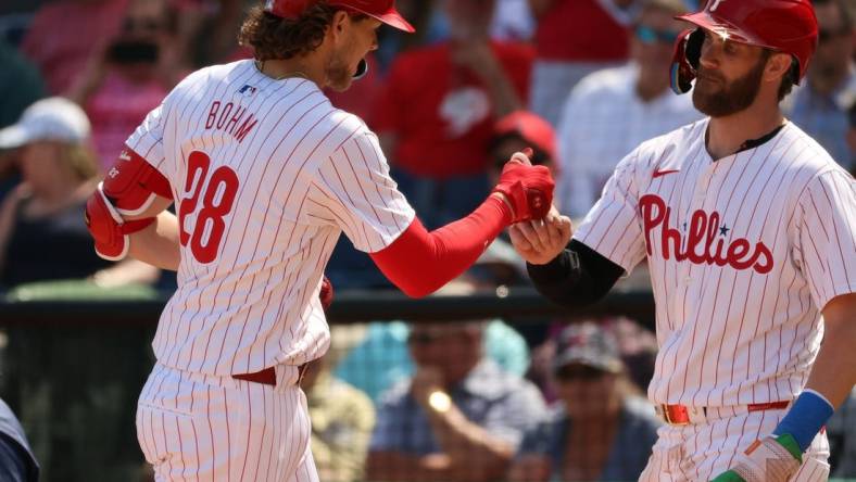 Feb 28, 2024; Clearwater, Florida, USA; Philadelphia Phillies infielder Alex Bohm (28) is congratulated by first baseman Bryce Harper (3) after he hit a two-run home run during the first inning against the Atlanta Braves  at BayCare Ballpark. Mandatory Credit: Kim Klement Neitzel-USA TODAY Sports