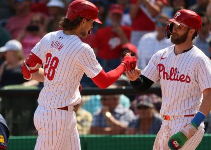 Feb 28, 2024; Clearwater, Florida, USA; Philadelphia Phillies infielder Alex Bohm (28) is congratulated by first baseman Bryce Harper (3) after he hit a two-run home run during the first inning against the Atlanta Braves  at BayCare Ballpark. Mandatory Credit: Kim Klement Neitzel-USA TODAY Sports