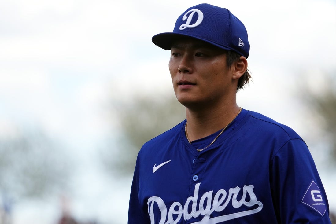 Feb 28, 2024; Surprise, Arizona, USA; Los Angeles Dodgers starting pitcher Yoshinobu Yamamoto (18) returns to the dugout during the first inning against the Texas Rangers at Surprise Stadium. Mandatory Credit: Joe Camporeale-USA TODAY Sports