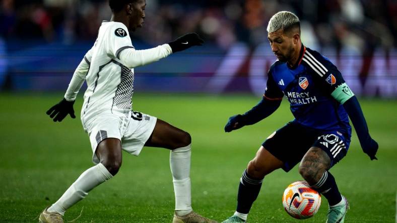 FC Cincinnati midfielder Luciano Acosta (10) handles the ball as Cavalier FC midfielder Dwayne Allen (13) guards him in the second half of the MLS match between the FC Cincinnati and the Cavalier FC at TQL Stadium in Cincinnati on Wednesday, Feb. 28, 2024.