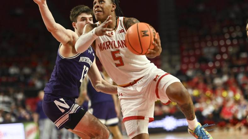 Feb 28, 2024; College Park, Maryland, USA;  Maryland Terrapins guard DeShawn Harris-Smith (5) shoots on Northwestern Wildcats guard Brooks Barnhizer (13) during the second half at Xfinity Center. Mandatory Credit: Tommy Gilligan-USA TODAY Sports