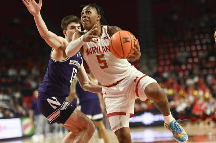 Feb 28, 2024; College Park, Maryland, USA;  Maryland Terrapins guard DeShawn Harris-Smith (5) shoots on Northwestern Wildcats guard Brooks Barnhizer (13) during the second half at Xfinity Center. Mandatory Credit: Tommy Gilligan-USA TODAY Sports