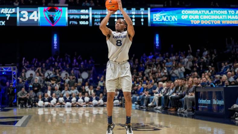 Xavier Musketeers guard Quincy Olivari (8) scores from three point range in the second half of the NCAA Big East conference basketball game between the Xavier Musketeers and the DePaul Blue Demons at the Cintas Center in Cincinnati on Wednesday, Feb. 28, 2024.