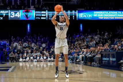 Xavier Musketeers guard Quincy Olivari (8) scores from three point range in the second half of the NCAA Big East conference basketball game between the Xavier Musketeers and the DePaul Blue Demons at the Cintas Center in Cincinnati on Wednesday, Feb. 28, 2024.