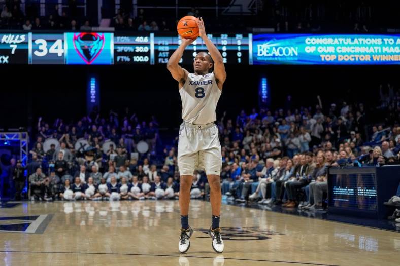 Xavier Musketeers guard Quincy Olivari (8) scores from three point range in the second half of the NCAA Big East conference basketball game between the Xavier Musketeers and the DePaul Blue Demons at the Cintas Center in Cincinnati on Wednesday, Feb. 28, 2024.