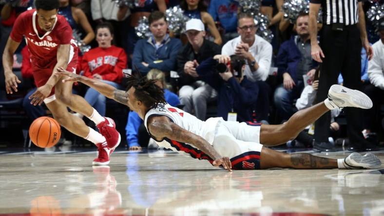 Feb 28, 2024; Oxford, Mississippi, USA; Mississippi Rebels guard Allen Flanigan (7) dives for a loose ball as Alabama Crimson Tide guard Rylan Griffen (3) scoops it up during the first half at The Sandy and John Black Pavilion at Ole Miss. Mandatory Credit: Petre Thomas-USA TODAY Sports