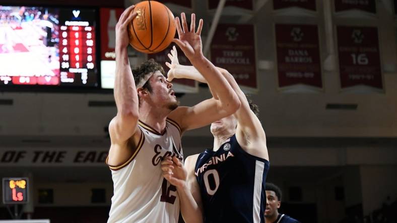 Feb 28, 2024; Chestnut Hill, Massachusetts, USA; Boston College Eagles forward Quinten Post (12) shoots the ball  against Virginia Cavaliers forward Blake Buchanan (0) during the second half at Conte Forum. Mandatory Credit: Eric Canha-USA TODAY Sports