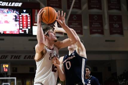 Feb 28, 2024; Chestnut Hill, Massachusetts, USA; Boston College Eagles forward Quinten Post (12) shoots the ball  against Virginia Cavaliers forward Blake Buchanan (0) during the second half at Conte Forum. Mandatory Credit: Eric Canha-USA TODAY Sports