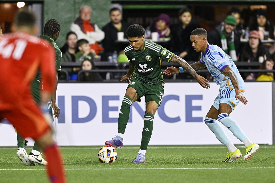 Feb 24, 2024; Oregon, Oregon, USA; Portland Timbers forward Antony (11) controls the ball during the second half against Colorado Rapids forward Calvin Harris (14) at Providence Park. Mandatory Credit: Troy Wayrynen-USA TODAY Sports