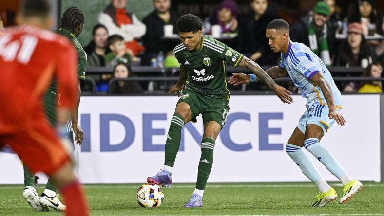 Feb 24, 2024; Oregon, Oregon, USA; Portland Timbers forward Antony (11) controls the ball during the second half against Colorado Rapids forward Calvin Harris (14) at Providence Park. Mandatory Credit: Troy Wayrynen-USA TODAY Sports