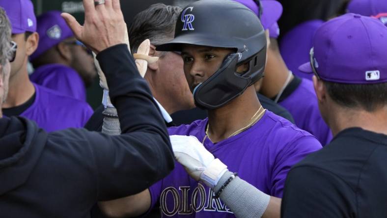 Feb 29, 2024; Mesa, Arizona, USA; Colorado Rockies shortstop Ezequiel Tovar (14) celebrates with teammates after hitting a solo home run against the Chicago Cubs in the third inning at Sloan Park. Mandatory Credit: Rick Scuteri-USA TODAY Sports