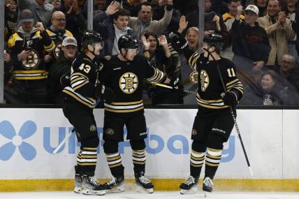 Feb 29, 2024; Boston, Massachusetts, USA; Boston Bruins center Morgan Geekie (39) (center) celebrates his goal with left wing Danton Heinen (43) and center Trent Frederic (11) during the first period against the Vegas Golden Knights at TD Garden. Mandatory Credit: Winslow Townson-USA TODAY Sports