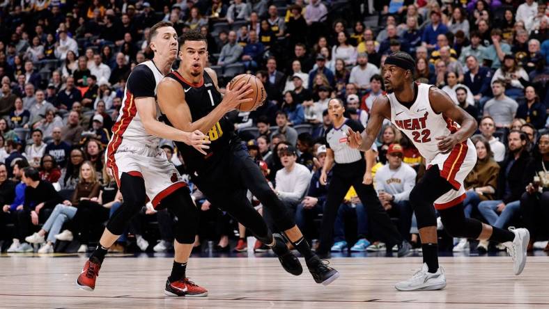 Feb 29, 2024; Denver, Colorado, USA; Denver Nuggets forward Michael Porter Jr. (1) drives to the basket against Miami Heat forward Duncan Robinson (55) in the first quarter at Ball Arena. Mandatory Credit: Isaiah J. Downing-USA TODAY Sports