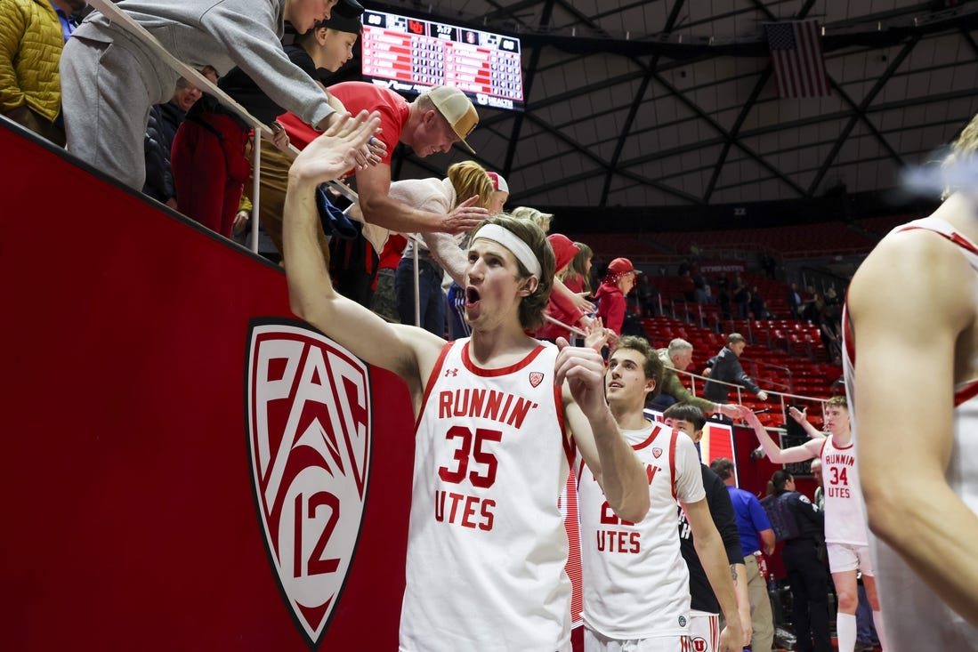 Feb 29, 2024; Salt Lake City, Utah, USA; Utah Utes center Branden Carlson (35) slaps hands with fans after the win against the Stanford Cardinal at Jon M. Huntsman Center. Mandatory Credit: Rob Gray-USA TODAY Sports