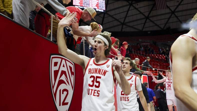 Feb 29, 2024; Salt Lake City, Utah, USA; Utah Utes center Branden Carlson (35) slaps hands with fans after the win against the Stanford Cardinal at Jon M. Huntsman Center. Mandatory Credit: Rob Gray-USA TODAY Sports