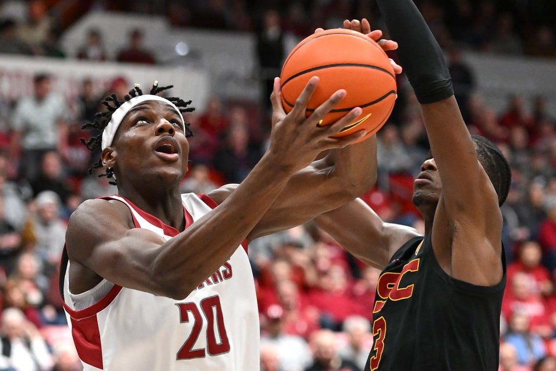 Feb 29, 2024; Pullman, Washington, USA; Washington State Cougars center Rueben Chinyelu (20) shoots the ball against USC Trojans forward Vincent Iwuchukwu (3) in the first half at Friel Court at Beasley Coliseum. Mandatory Credit: James Snook-USA TODAY Sports