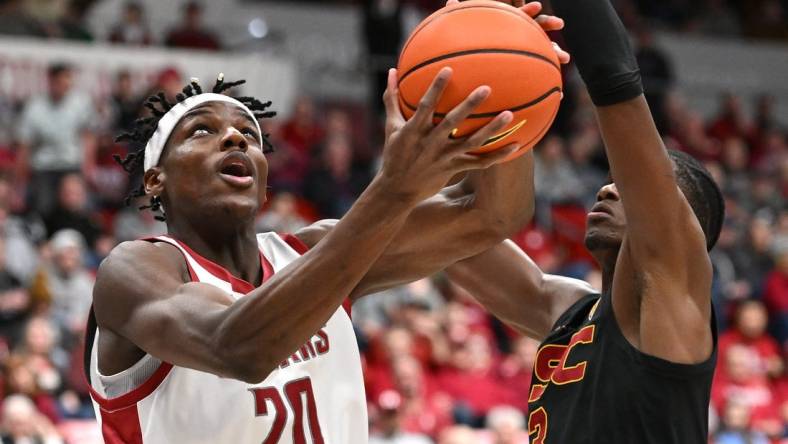 Feb 29, 2024; Pullman, Washington, USA; Washington State Cougars center Rueben Chinyelu (20) shoots the ball against USC Trojans forward Vincent Iwuchukwu (3) in the first half at Friel Court at Beasley Coliseum. Mandatory Credit: James Snook-USA TODAY Sports