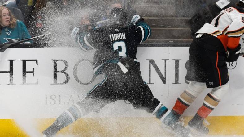 Feb 29, 2024; San Jose, California, USA; San Jose Sharks defenseman Henry Thrun (3) collides into the wall during the first period against the Anaheim Ducks at SAP Center at San Jose. Mandatory Credit: Stan Szeto-USA TODAY Sports